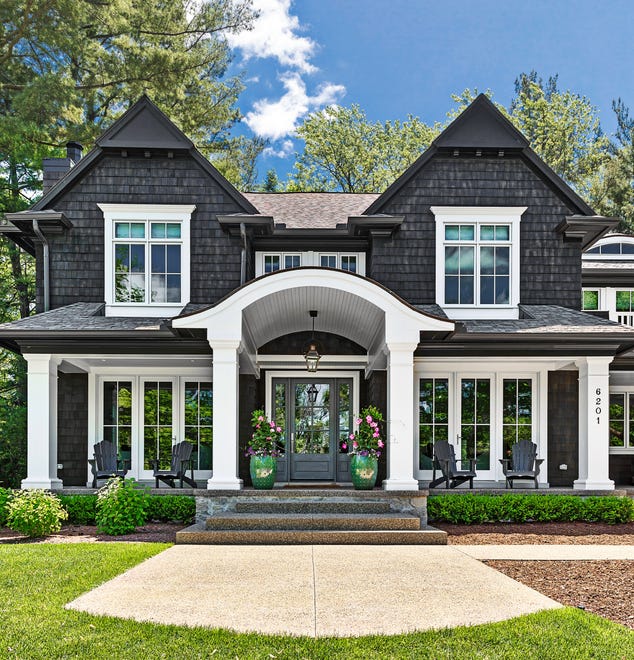 Talk about a bold statement. Mike and Kim Petrucci of Bloomfield Hills decided to stain the cedar shake siding on their home a lightened version of Benjamin Moore's Black Onyx.