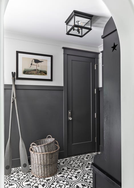 A porcelain tile in the guest mudroom was inspired by a tile Kim saw at a hotel in Tampa. The oars contribute to the home's coastal vibe.