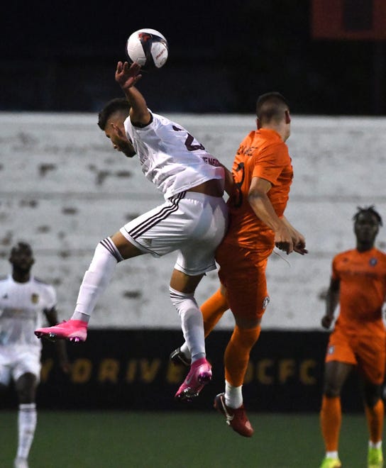 DCFC's Kevin Venegas and New Amsterdam FC's Alvarez go up for a header in the first half.