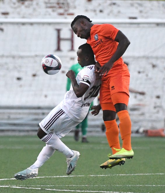 DCFC's Evans Frimpong handles the pressure by New Amsterdam FC's Yusuf Mikaheel in the first half.