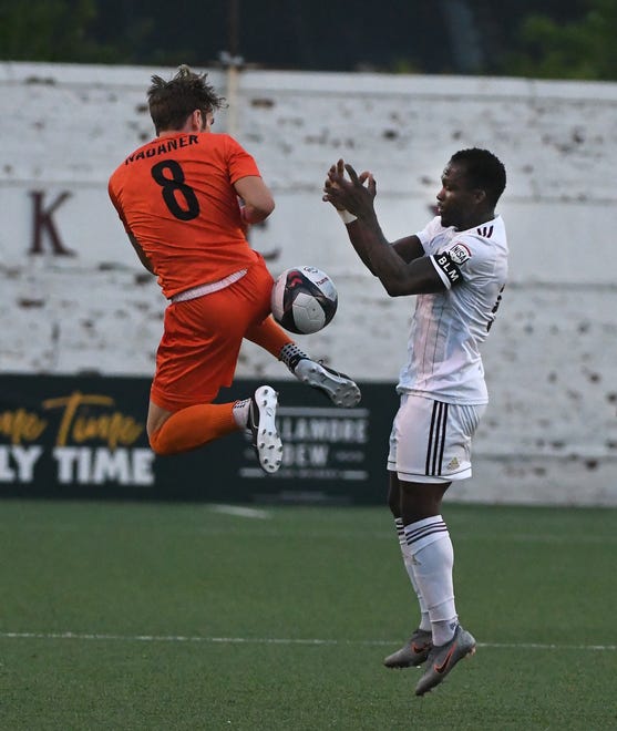 New Amsterdam FC's Even Nadaner goes up for the ball against DCFC's Ibrahim Conteh in the first half.