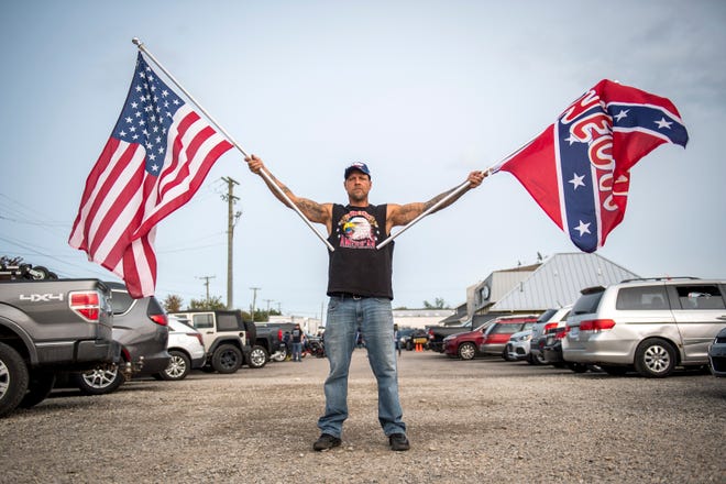 Paul Johnson of Roseville poses for a portrait before the Make America Great Again rally with Donald Trump Jr. and Kid Rock at Bumpers Landing Boat Club in Harrison Township. “ I love this place. This is the epitome of what America is supposed to be about — waving American flags, being free, ” Johnson said.