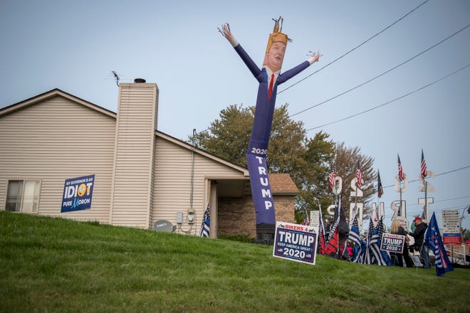 A Trump inflatable waves in the air before the Make America Great Again rally with Donald Trump Jr. and Kid Rock at Bumpers Landing Boat Club in Harrison Township.