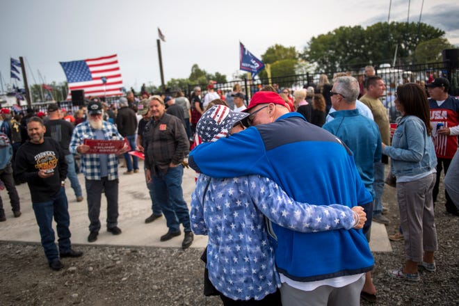 Joanna Smith of Sterling Heights kisses her husband, John Smith, before the Make America Great Again rally.