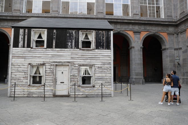 The house of U.S. civil rights campaigner Rosa Parks, rebuilt by artist Ryan Mendoza, is on display in the courtyard of an 18th century Royal Palace, in Naples, Italy, Tuesday, Sept. 15, 2020. Itâ€™s the latest stop for the house in a years-long saga that began when Parksâ€™ niece saved the tiny two-story home from demolition in Detroit after the 2008 financial crisis. (AP Photo/Gregorio Borgia)