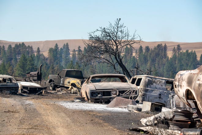Vehicles destroyed by a wildfire are shown Tuesday, Sept. 8, 2020, in Malden, Wash.