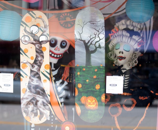 "The Hollow" by Connor Jordan of Rochester Hills and "Night at the Pumpkin Patch" by Joseph Micallef of Troy fit well in the window of The Urban Merchant.