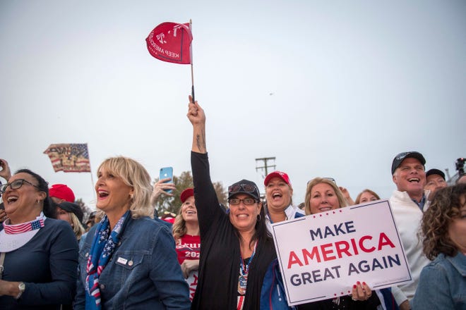 Trump supporters cheer during the Make America Great Again rally with Donald Trump Jr. and Kid Rock at Bumpers Landing Boat Club in Harrison Township, Mich on Sept. 14, 2020.