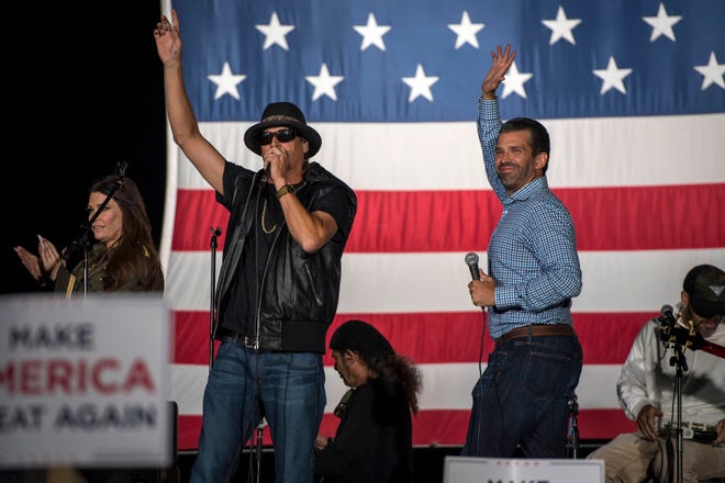 Kid Rock and Donald Trump Jr. wave to the crowd during the Make America Great Again rally with Donald Trump Jr. and Kid Rock at Bumpers Landing Boat Club in Harrison Township, Mich., on Sept. 14, 2020.