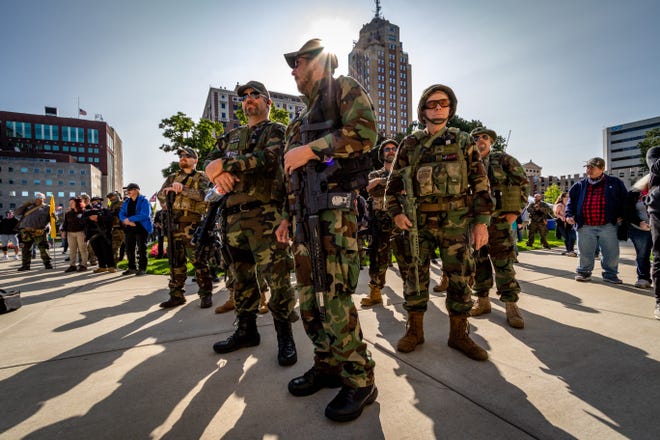 Militia members listen to a speaker as gun rights advocates rally for the Second Amendment March at the Capitol Building in Lansing, Michigan on September 17, 2020.