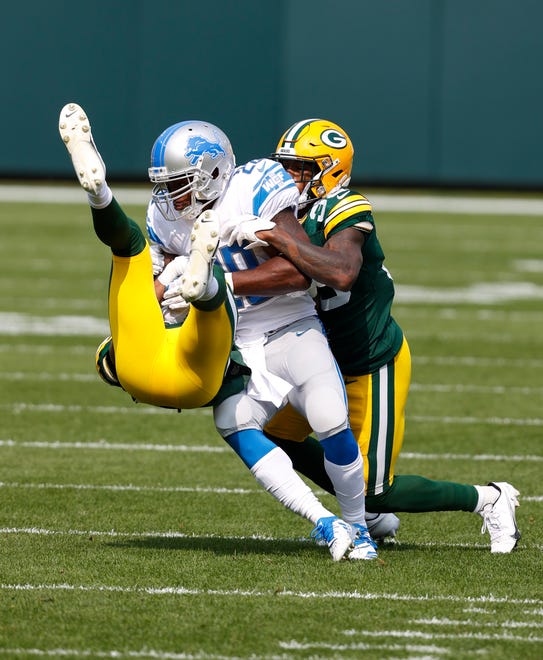 Detroit Lions' Adrian Peterson is tackled by the Green Bay Packers during an NFL football game, Sunday, Sept. 20, 2020, in Green Bay, Wis.