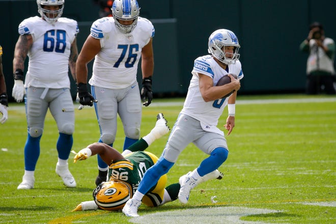 Detroit Lions' Matthew Stafford runs for a first down during the first half of an NFL football game against the Green Bay Packers Sunday, Sept. 20, 2020, in Green Bay, Wis.