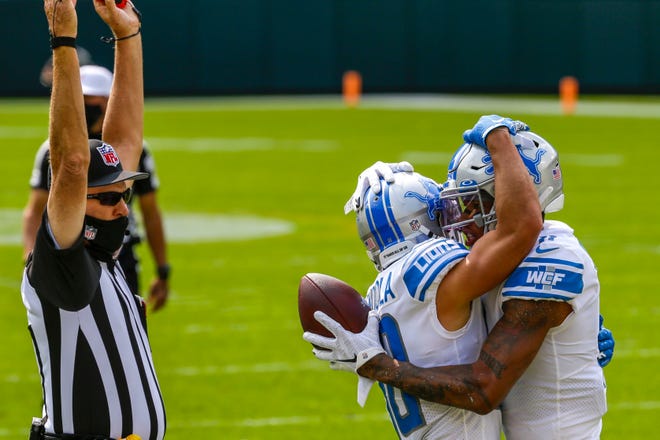 Detroit Lions' Marvin Jones celebrates his touchdown catch with teammate Danny Amendola during the first half of an NFL football game against the Green Bay Packers Sunday, Sept. 20, 2020, in Green Bay, Wis.