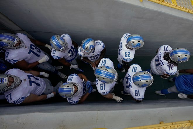 Detroit Lions players wait in the tunnel to be introduced before an NFL football game against the Green Bay Packers Sunday, Sept. 20, 2020, in Green Bay, Wis.