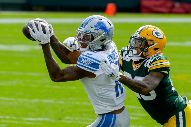 Detroit Lions' Marvin Jones catches a pass with Green Bay Packers' Jaire Alexander defending during the first half of an NFL football game Sunday, Sept. 20, 2020, in Green Bay, Wis.