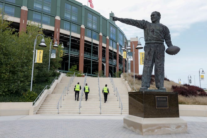 Security personel walk up some stairs outside Lambeau Field before the game.