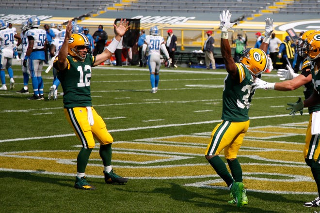 Green Bay Packers' Aaron Jones celebrates his touchdown run with Aaron Rodgers (12) during the second half of an NFL football game against the Detroit Lions Sunday, Sept. 20, 2020, in Green Bay, Wis.