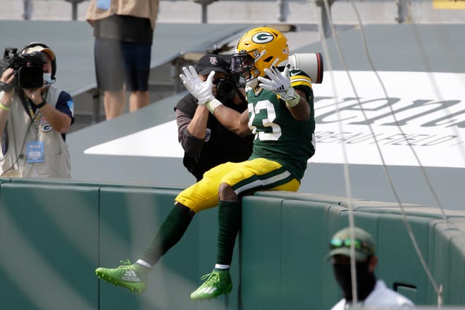 Green Bay Packers' Aaron Jones celebrates his touchdown catch during the first half of an NFL football game against the Detroit Lions Sunday, Sept. 20, 2020, in Green Bay, Wis.