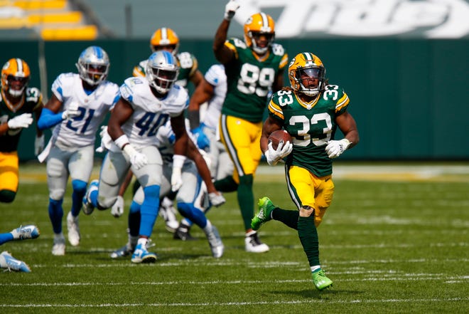 Green Bay Packers' Aaron Jones runs for a touchdown during the second half of an NFL football game against the Detroit Lions Sunday, Sept. 20, 2020, in Green Bay, Wis.