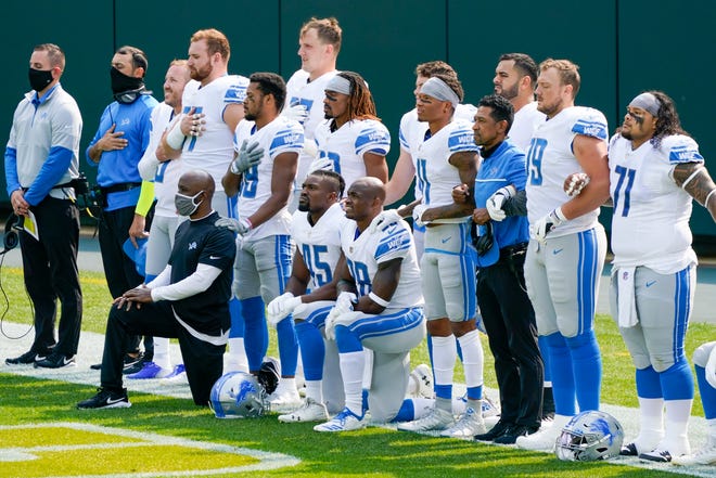 Some Detroit Lions player take a knee during the national anthem before an NFL football game against the Green Bay Packers Sunday, Sept. 20, 2020, in Green Bay, Wis.