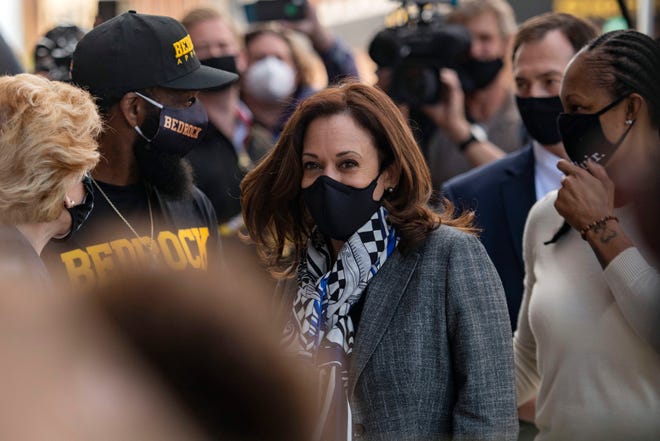Democratic vice presidential candidate Sen. Kamala Harris, D-Calif., greets supporters as she visits different businesses that have been impacted by the coronavirus pandemic, Tuesday in Flint, Mich.