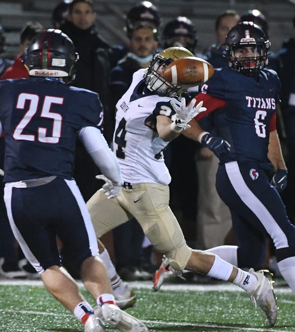 Grosse Pointe South ' s Egan Sullivan bobbles the ball but can ' t pull it in, leaving it for Stevenson ' s Justin Smith and the interception in the first half.