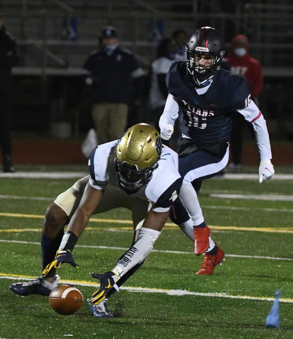 Grosse Pointe South quarterback Will Johnson has to chase a missed exchange from center and is sacked behind the line of scrimmage by Stevenson's Justin Smith in the second half.