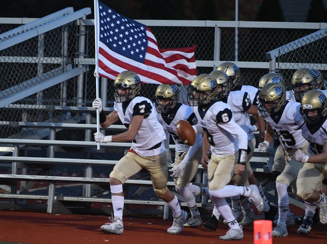 Grosse Pointe South players make their way onto the field for the game against Sterling Heights Stevenson.