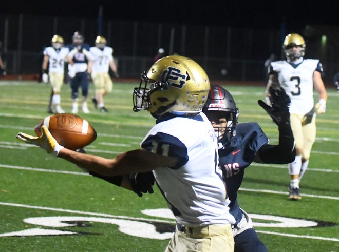 Grosse Pointe South's Charlie Brandon pulls in a long first-down reception in the second half.
