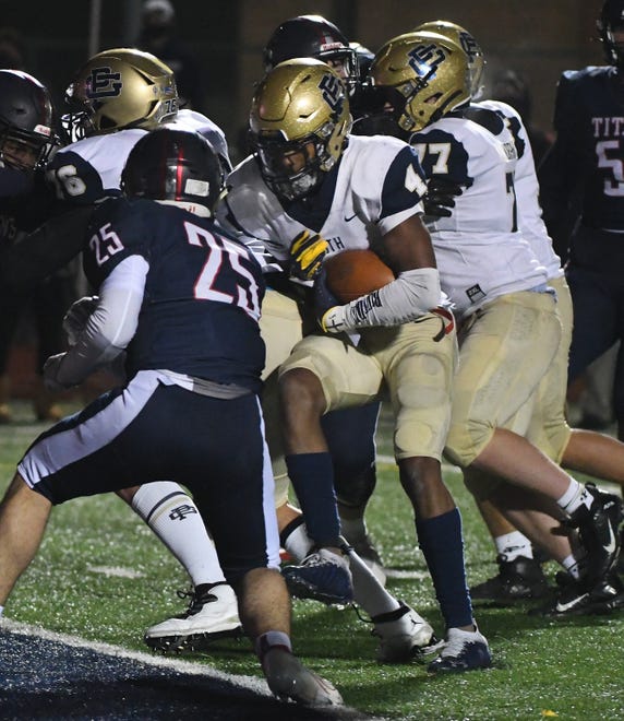 Grosse Pointe South's Will Johnson runs the ball into the end zone, which tied it 35-35 after the extra point, late in the second half.