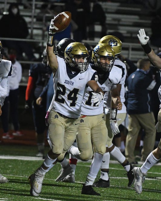 Grosse Pointe South's Egan Sullivan celebrates after stealing the ball away from Stevenson's Tony Shumate on a kick return for the turnover deep in Stevenson territory in the second half.