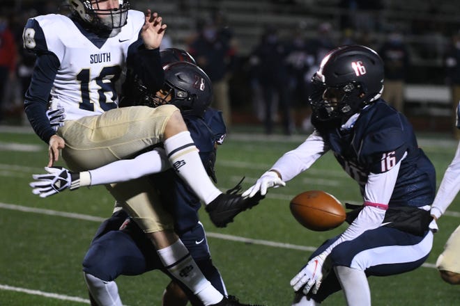 Grosse Pointe South punter Smihal Bennet tries to kick the ball away but Stevenson's T.J. Castleberry and Justin Smith block the kick and Stevenson recovers in the second half.