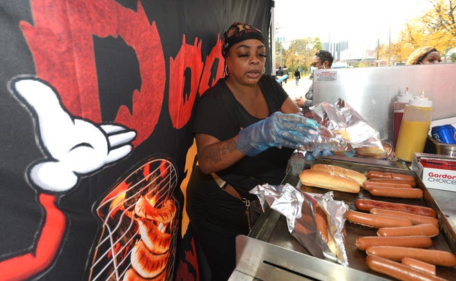 Unita Hogan, of Warren, fills hot dog orders. She is the owner of Dogging It By Nita.