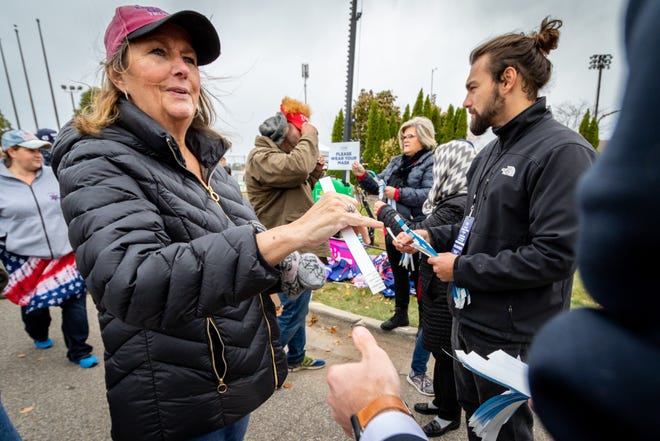 Flora Stout of Norton Shores gets a wristband in line indicating she's been temperature-checked. President Donald Trump spoke to supporters at a rally at Muskegon County Airport in Muskegon on Oct. 17, 2020.