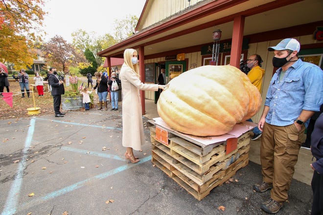 Manager Allen Robinette introduces Ivanka Trump to a giant pumpkin as she makes a surprise visit to Robinette’s Orchard in Grand Rapids on October 19, 2020.