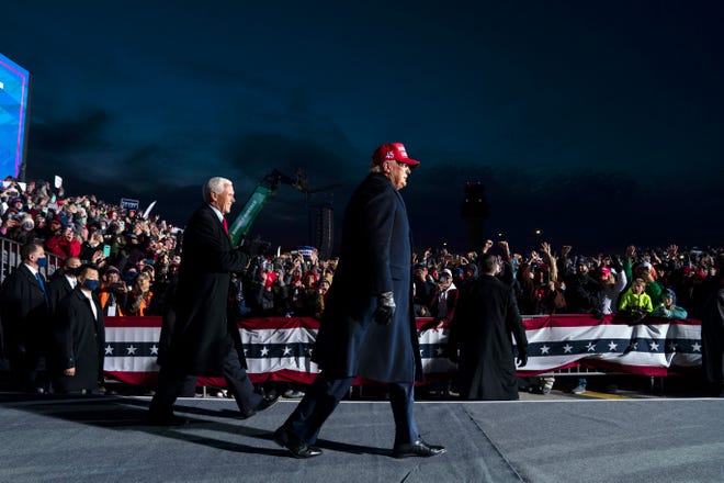 President Donald Trump and Vice President Mike Pence arrive for a campaign rally at Cherry Capital Airport, Monday, Nov. 2, 2020, in Traverse City, Mich.