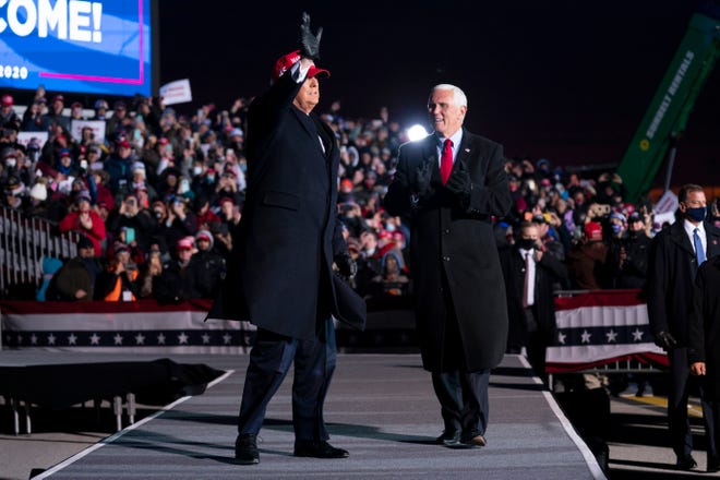 President Donald Trump and Vice President Mike Pence arrive for a campaign rally at Cherry Capital Airport, Monday, Nov. 2, 2020, in Traverse City, Mich.