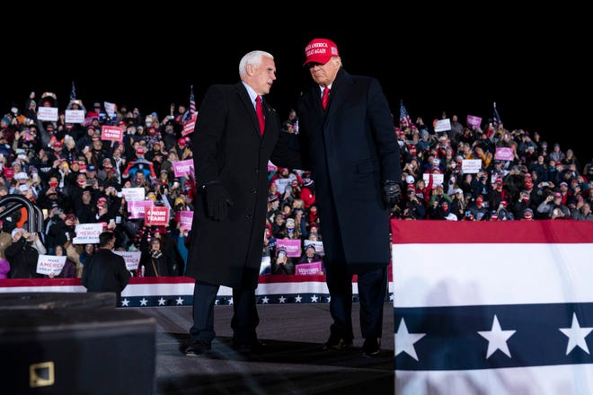 President Donald Trump and Vice President Mike Pence arrive for a campaign rally at Gerald R. Ford International Airport, Monday, Nov. 2, 2020, in Grand Rapids, Mich.