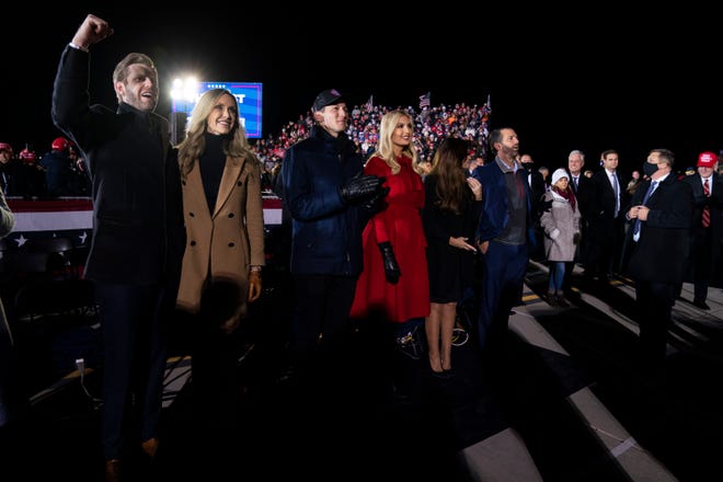 Eric Trump and his wife Lara Trump, Ivanka Trump and her husband Jared Kushner, and Donald Trump Jr., and his girlfriend Kimberly Guilfoyle, listen as President Donald Trump speaks at campaign rally at Gerald R. Ford International Airport, Monday, Nov. 2, 2020, in Grand Rapids, Mich.