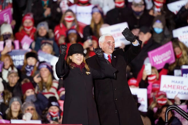 Vice President Mike Pence and his wife Karen wave before President Donald Trump arrives at a campaign rally Monday, Nov. 2, 2020, in Grand Rapids,