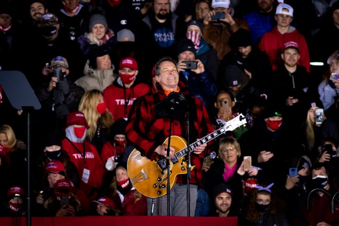 Ted Nugent plays the American National Anthem before President Donald Trump delivers remarks at his fifth and final rally of the day—and the campaign—at Gerald R. Ford Airport in Grand Rapids, Michigan on November 2, 2020.  The rally started at midnight and went into election day.