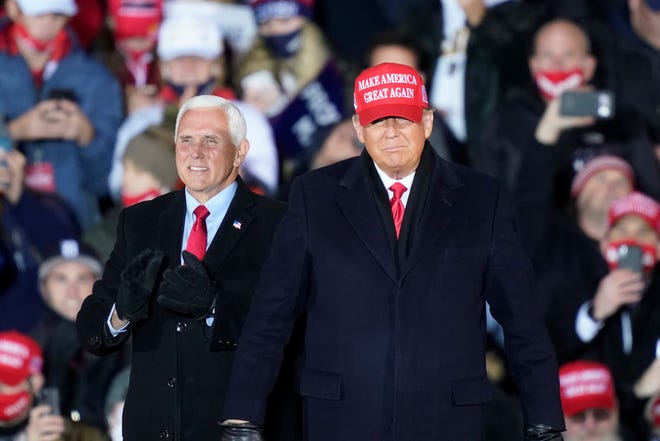 President Donald Trump arrives with Vice President Mike Pence for a campaign rally Monday, Nov. 2, 2020, in Grand Rapids, Mich.