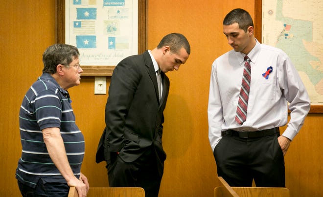 Greg Kelley, middle, and supporters wait for the verdict in his child-molestation trial July 15, 2014.