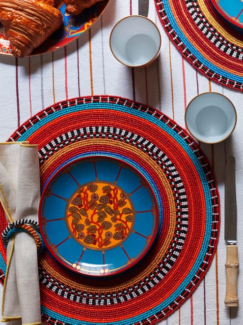 A multi-beaded place mat is inspired by vibrant color combinations and intricate jewelry patterns crafted by the Maasai tribe of Africa. The 15-inch place mat, available from Von Gern Home, is a stunning mate for a plate from Hermes' Ballets Russes collection.