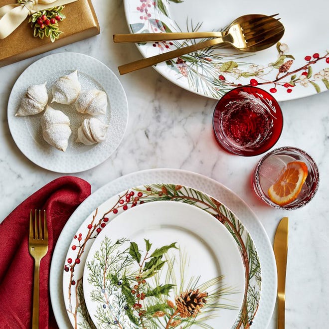 Winterberries, pine branches and cardinals are some of the motifs on the Woodland Berry collection of porcelain dinnerware at Williams Sonoma. They have a modern spirit because of their placement.