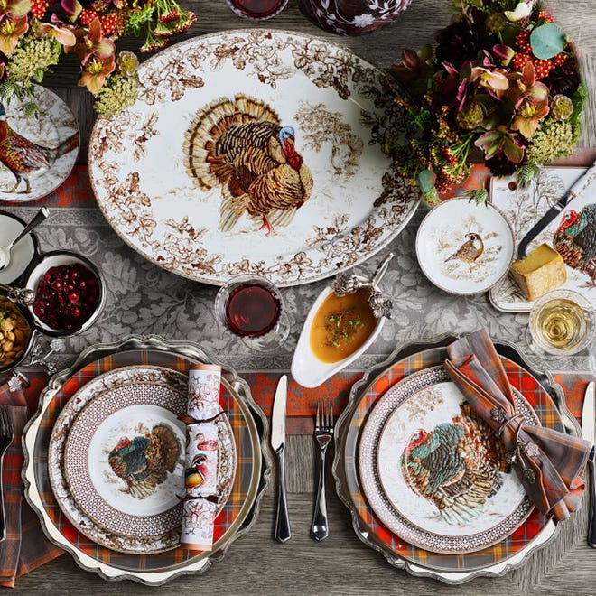 Here is the quintessential Thanksgiving table, layering at its best. The abbondanza mood is struck in a lush spread reflecting warm autumnal hues. Tradition mixes with a modern spirit, with turkey plates paired with a 12 1/4-inch Autumn plaid charger. The shades of orange and gray are picked up in a pretty cotton linen damask runner with a leaf and acorn pattern and bittersweet and rich tones in the florals. Dinnerware and linens are from Williams Sonoma.