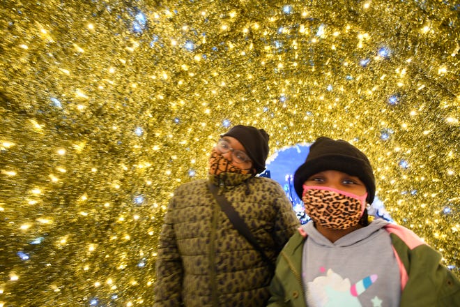 Lauryn Mitchell, 6  and sister Madisyn Mitchell, 10 explore the over 125, 000 twinkling lights at Beacon Park now through January 10th in Detroit, Michigan  on November 20, 2020.