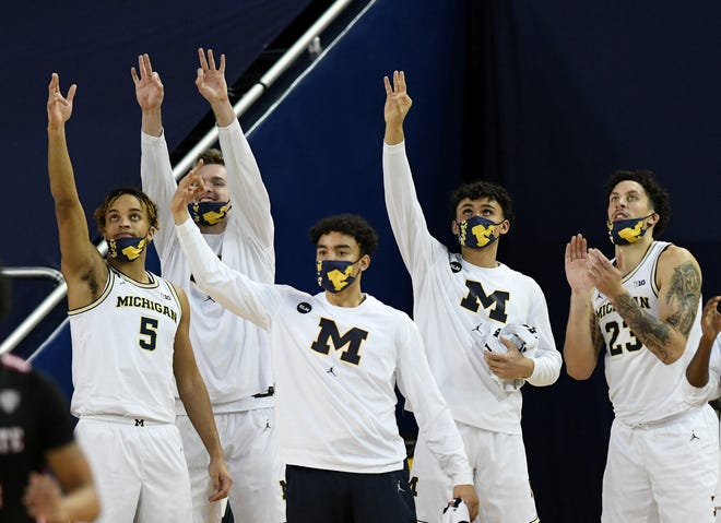 From left, Michigan's Terrance Williams II, Jaron Faulds,  Terrance Williams II, Adrien Nunez and Brandon Johns Jr. (23) react to a three-point-shot in the second half.  Michigan vs Ball State at Crisler Center in Ann Arbor, Mich. on Dec. 2, 2020.  Michigan wins, 84-65.