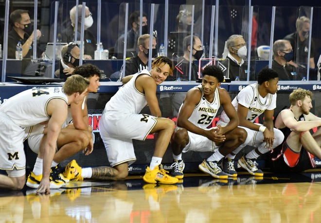 From left, Michigan's Jaron Faulds (44), Adrien Nunez (0), Terrance Williams II (5), Jace Howard (25) andd Zeb Jackson (3) about to enter the game in the second half.  Michigan vs Ball State at Crisler Center in Ann Arbor, Mich. on Dec. 2, 2020.  Michigan wins, 84-65.