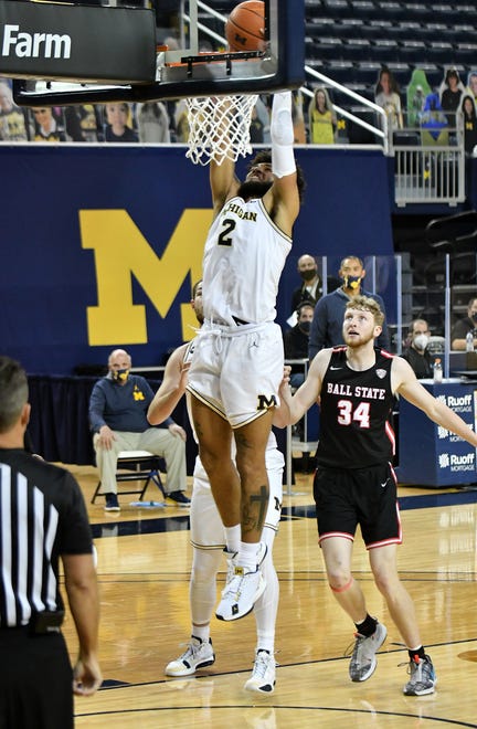 Michigan forward Isaiah Livers (2) dunks in front of Ball State center Ben Hendriks (34) in the second half.  Michigan vs Ball State at Crisler Center in Ann Arbor, Mich. on Dec. 2, 2020.  Michigan wins, 84-65.